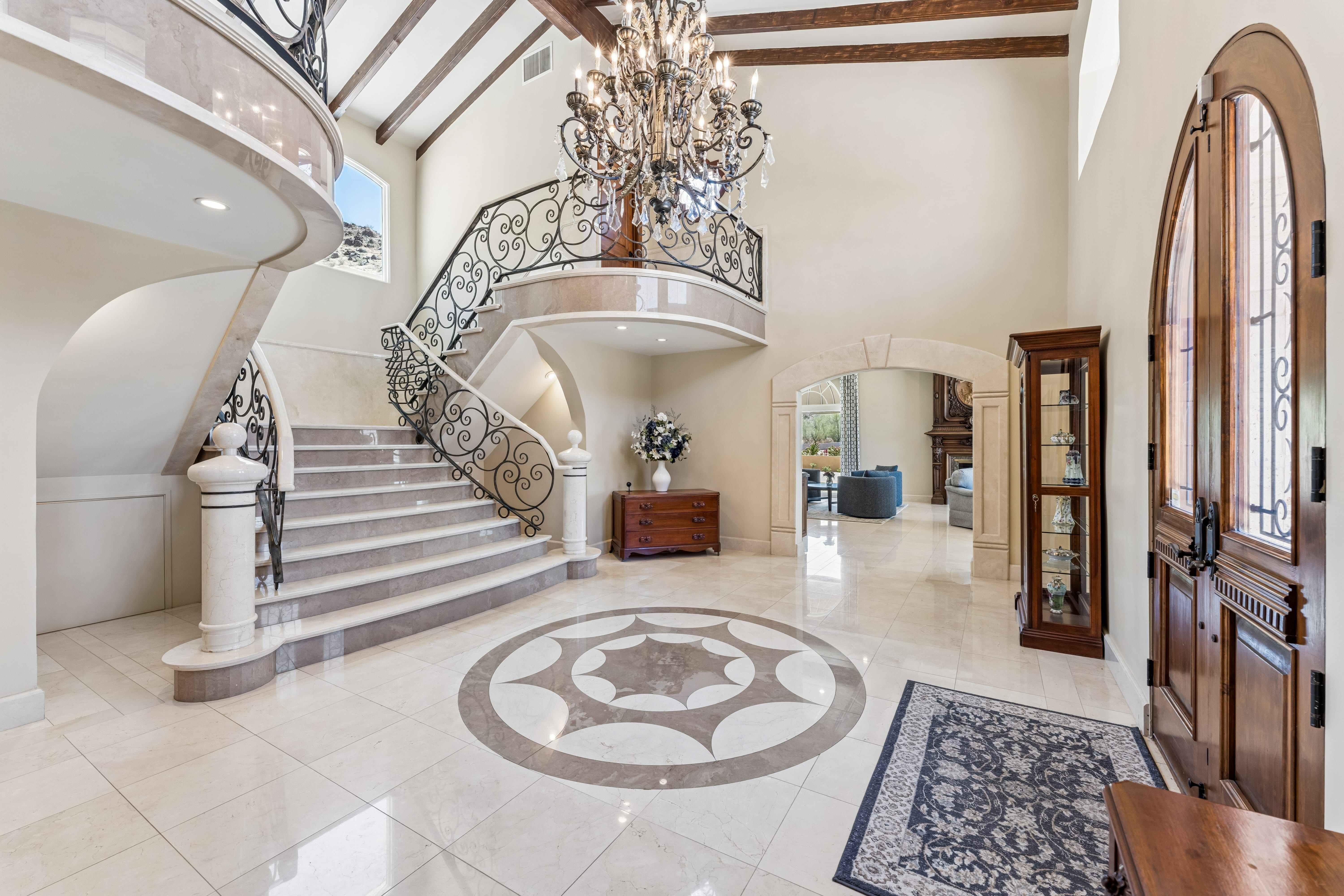 Sweeping marble staircase and two-story foyer