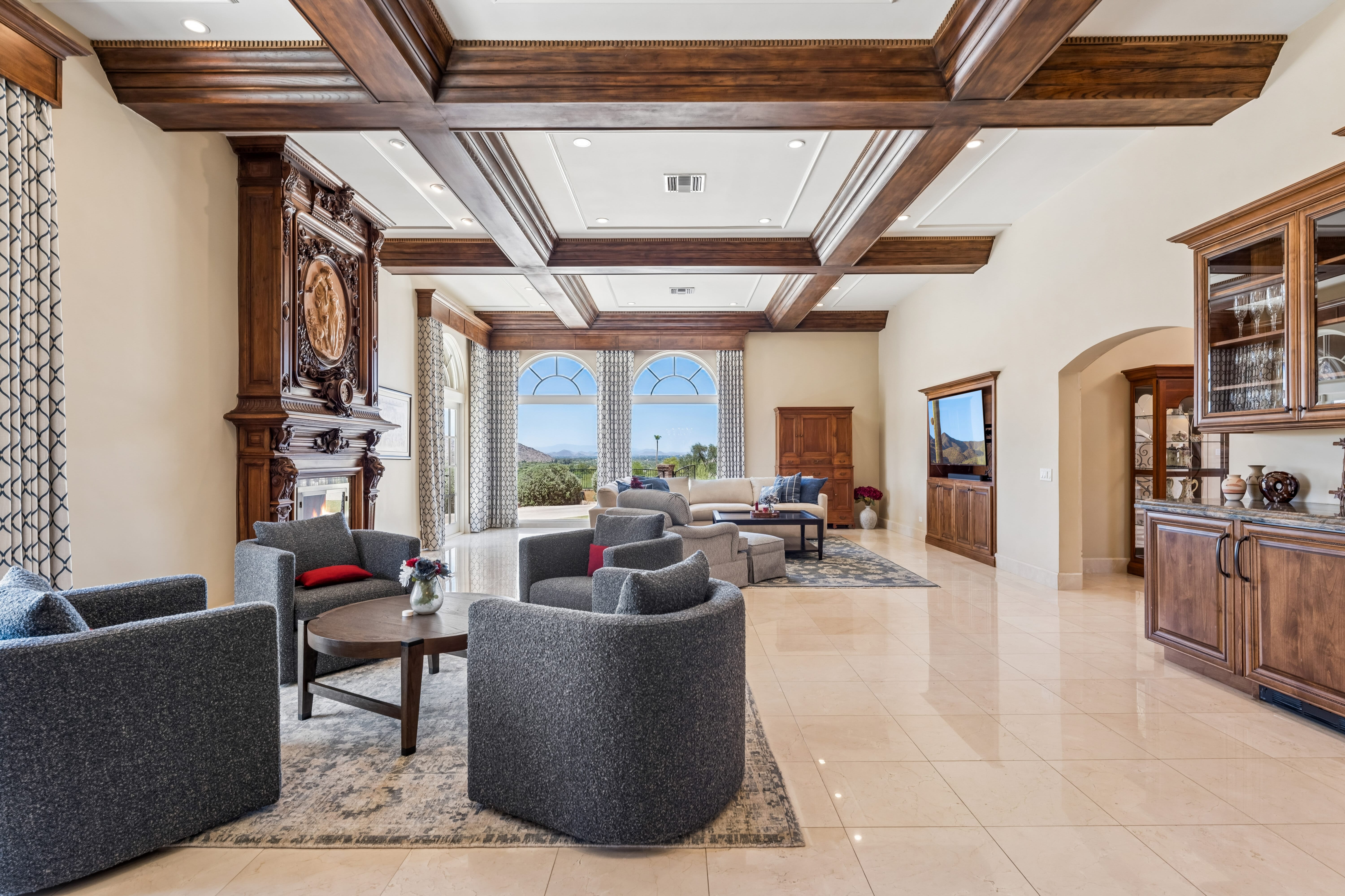Living room full view with coffered ceiling and arched windows