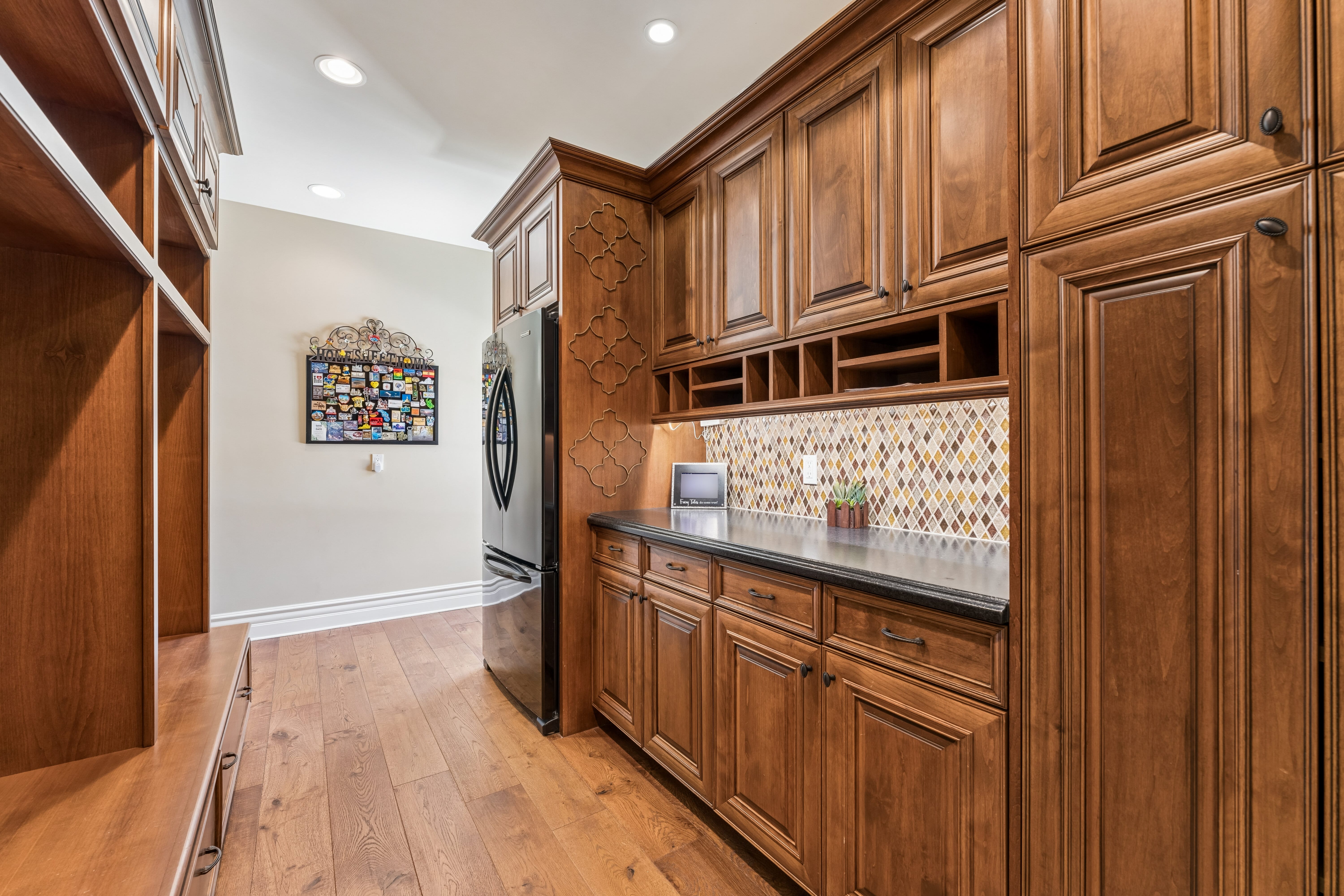 Mud Room with custom walnut cabinetry and mosaic backsplash