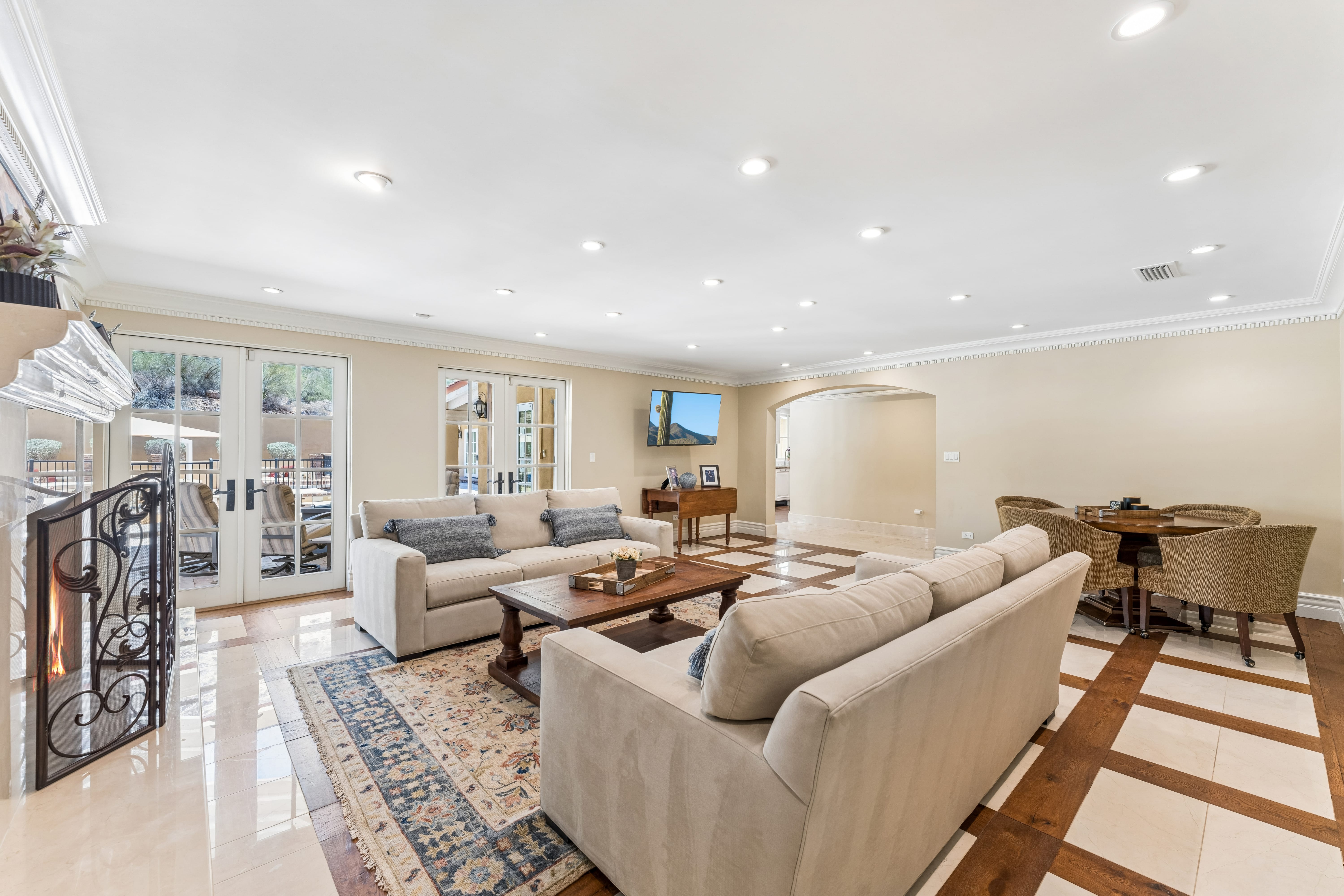 Family room with fireplace and French doors to pool deck
