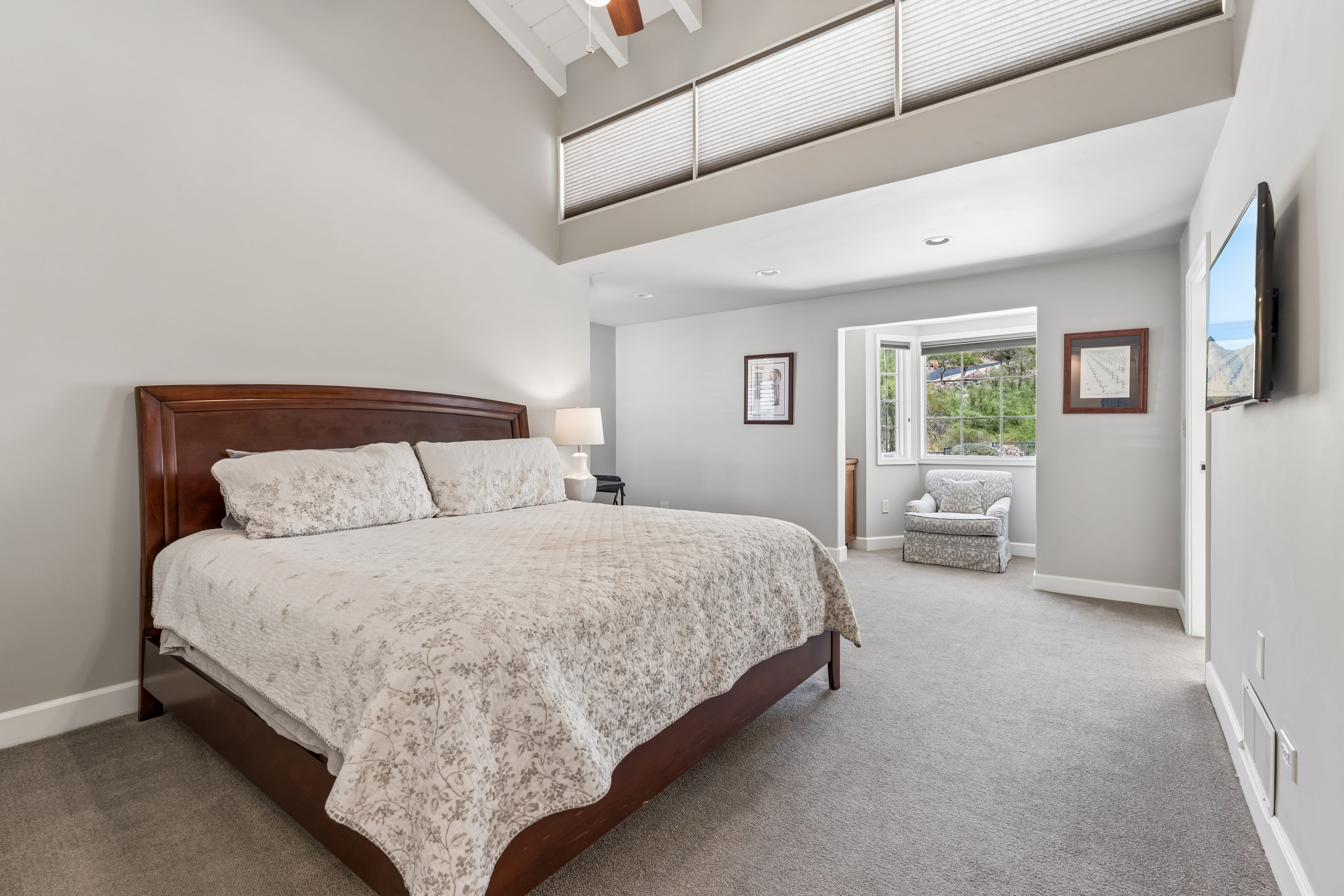 Second guest bedroom with vaulted ceiling and sitting area