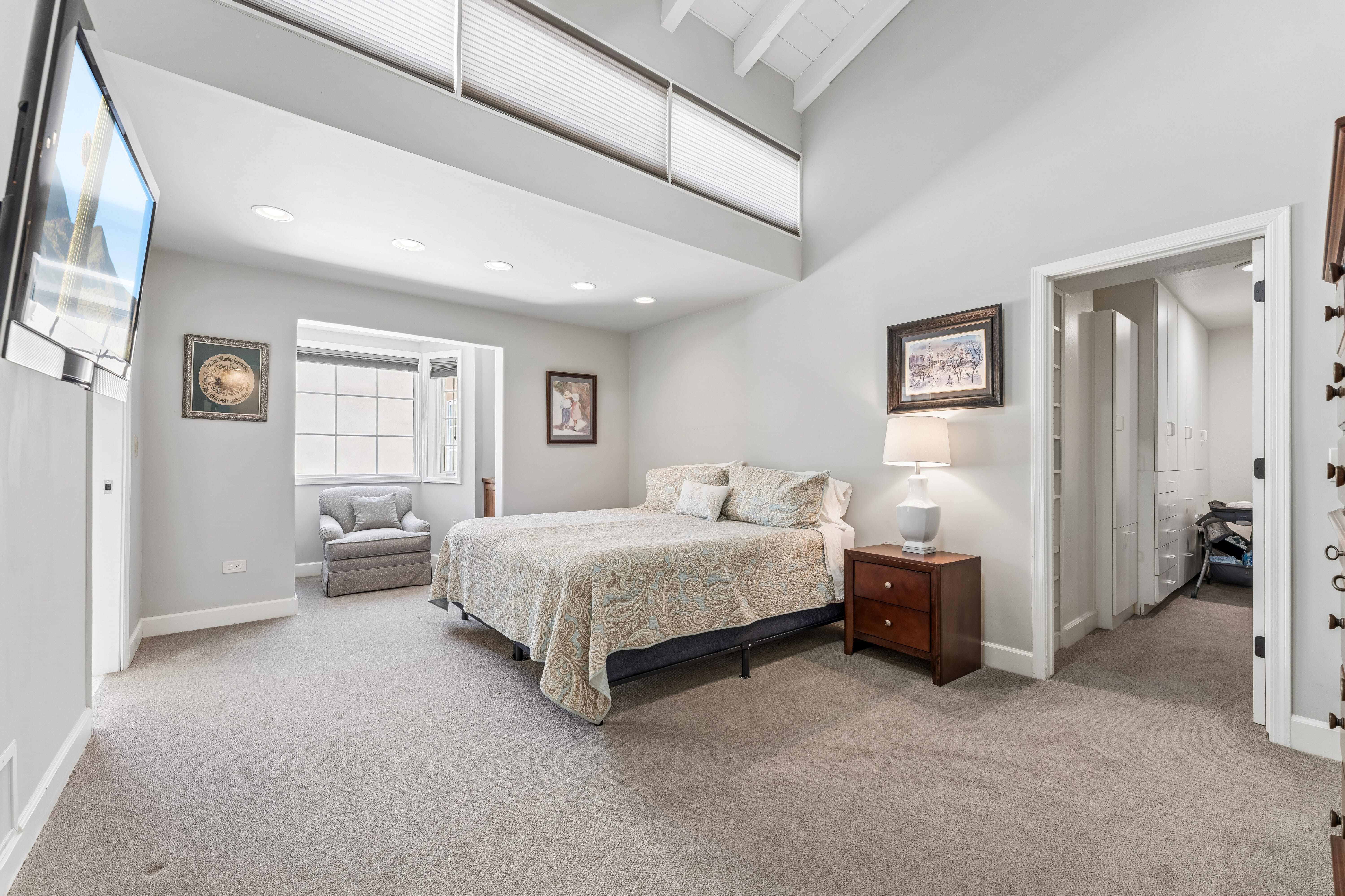 Guest bedroom with vaulted beamed ceiling and mountain views
