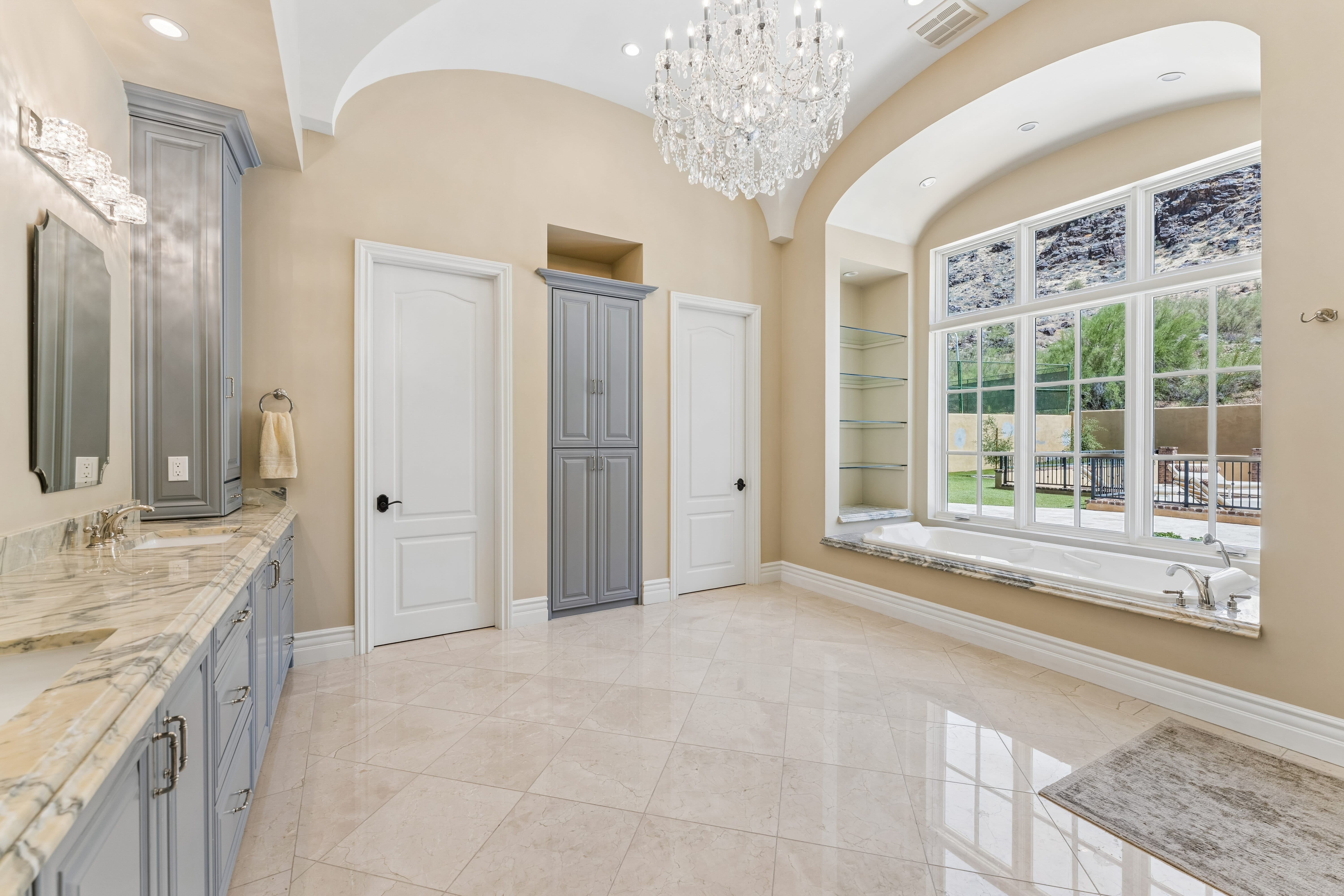 Primary bath with crystal chandelier and soaking tub