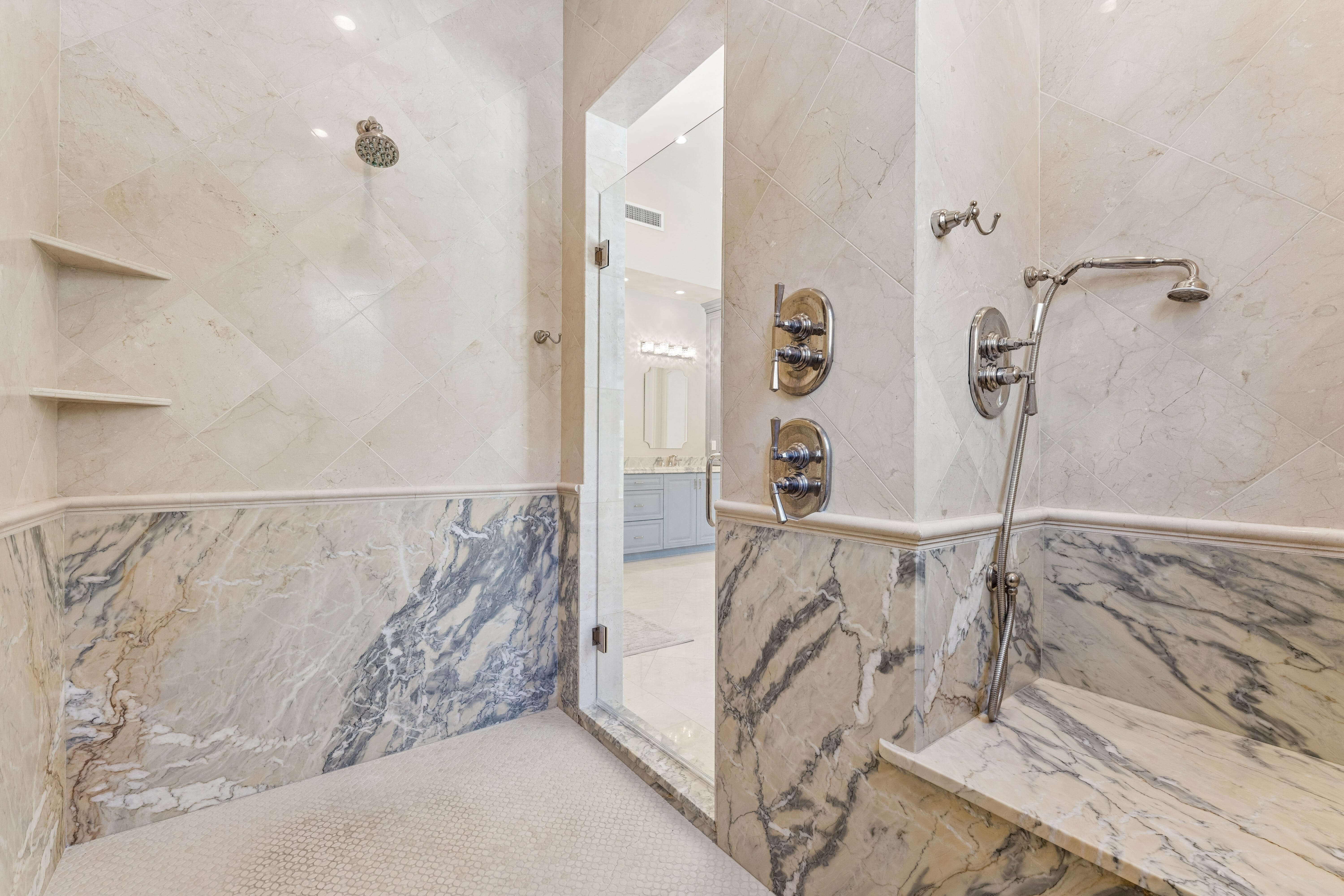 Primary shower with bookmatched Calacatta marble