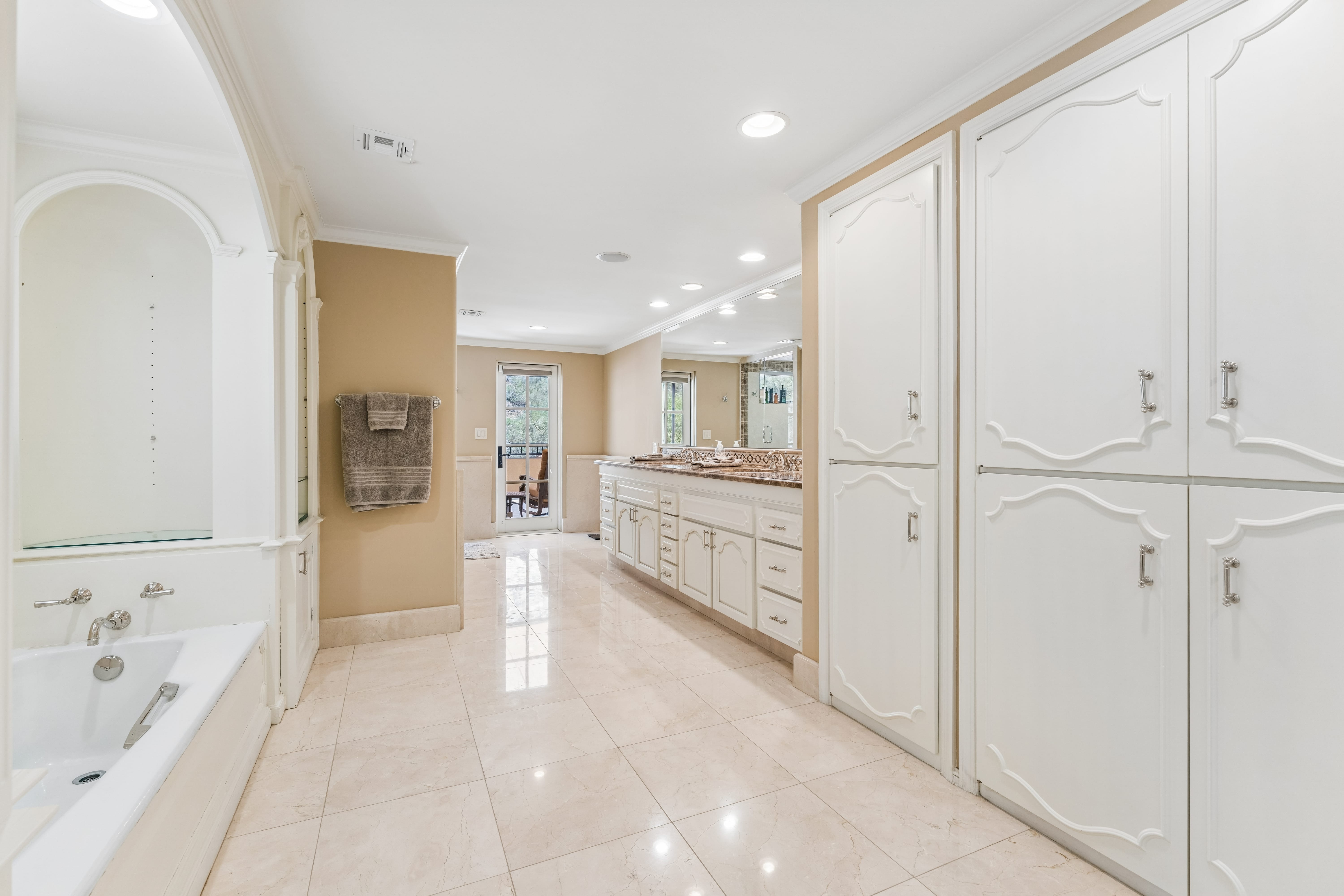 Second floor dressing room with ornate white cabinetry