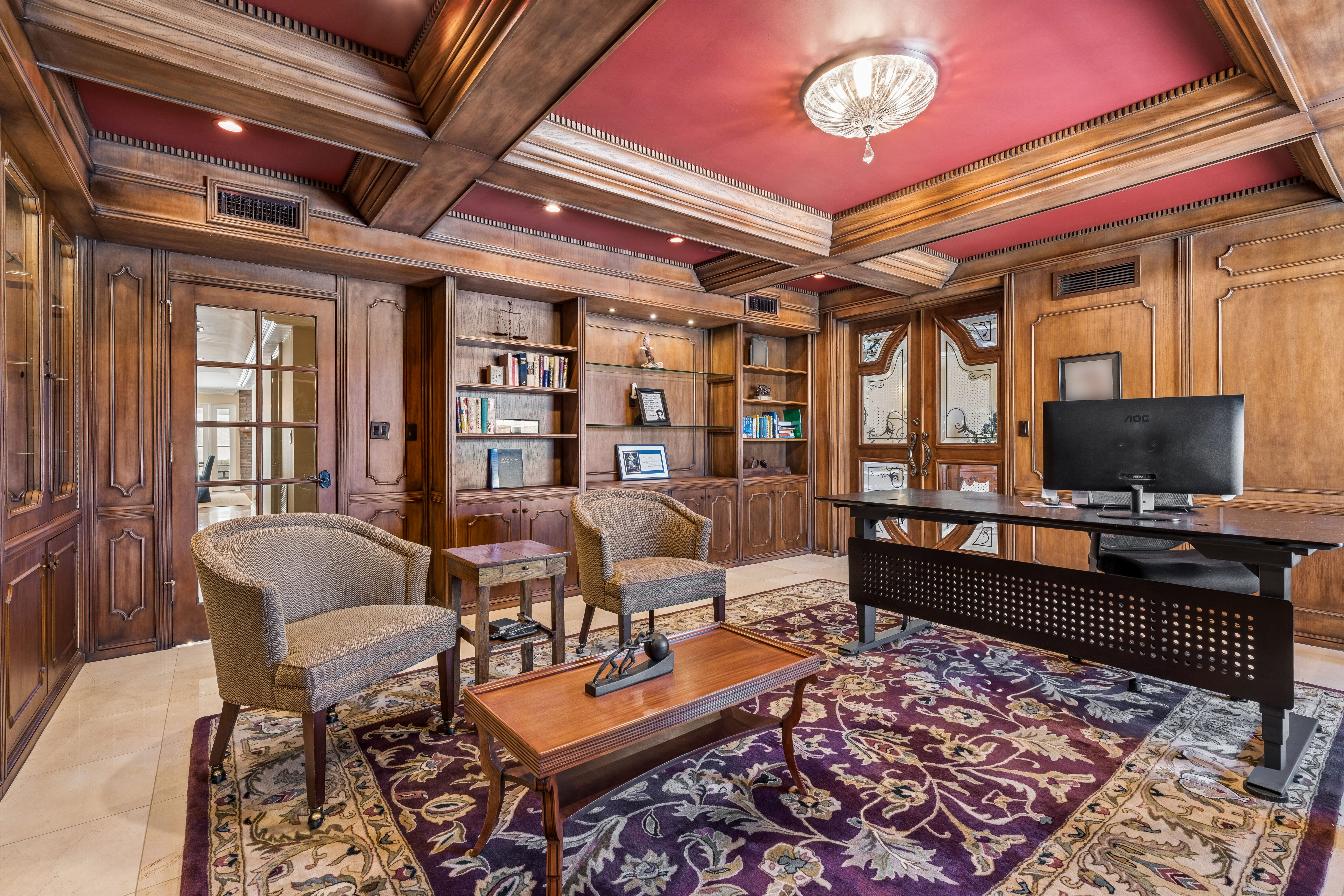 Private study with hand-carved walnut paneling and crimson coffered ceiling