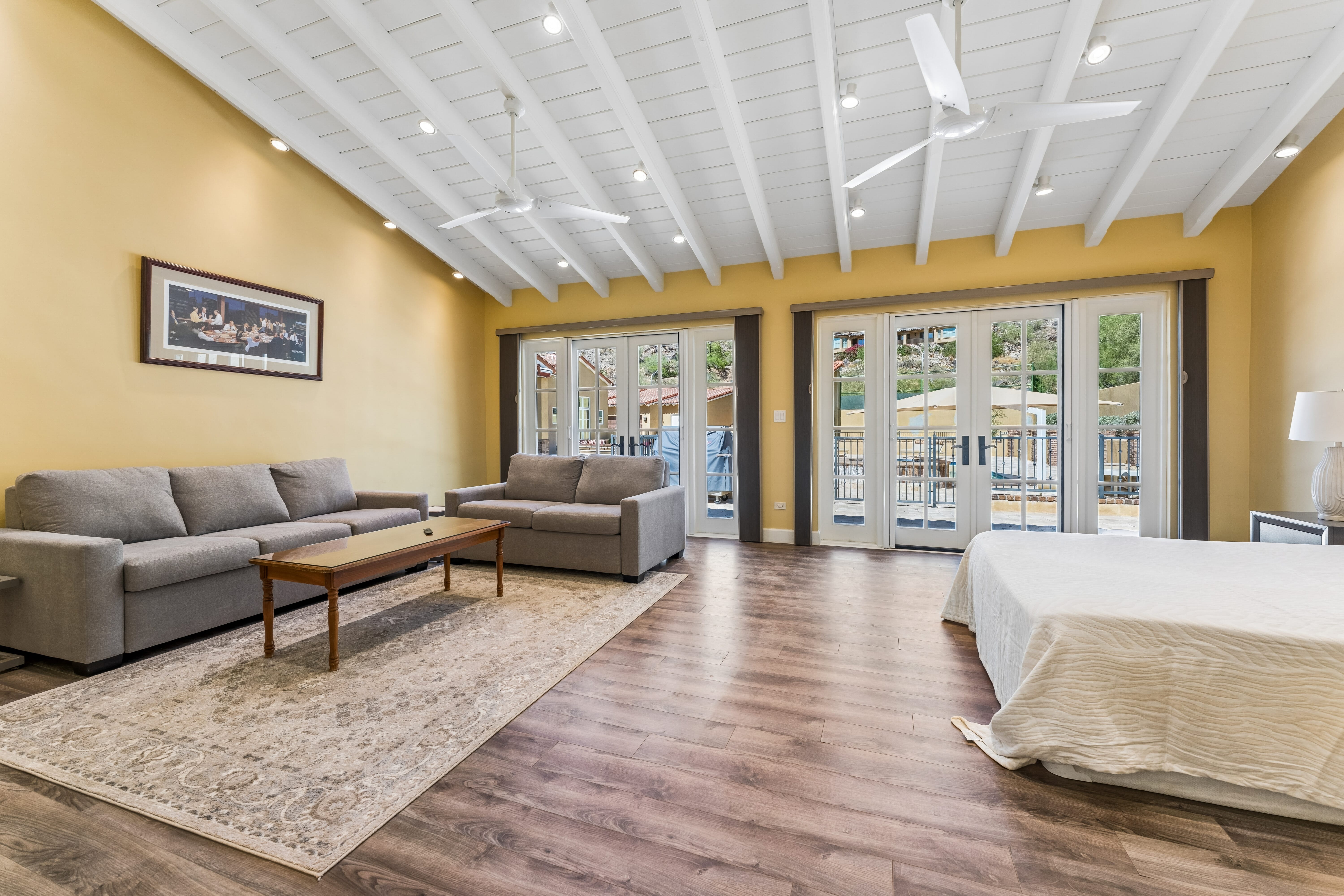 Casita living suite with vaulted ceiling and French doors to pool