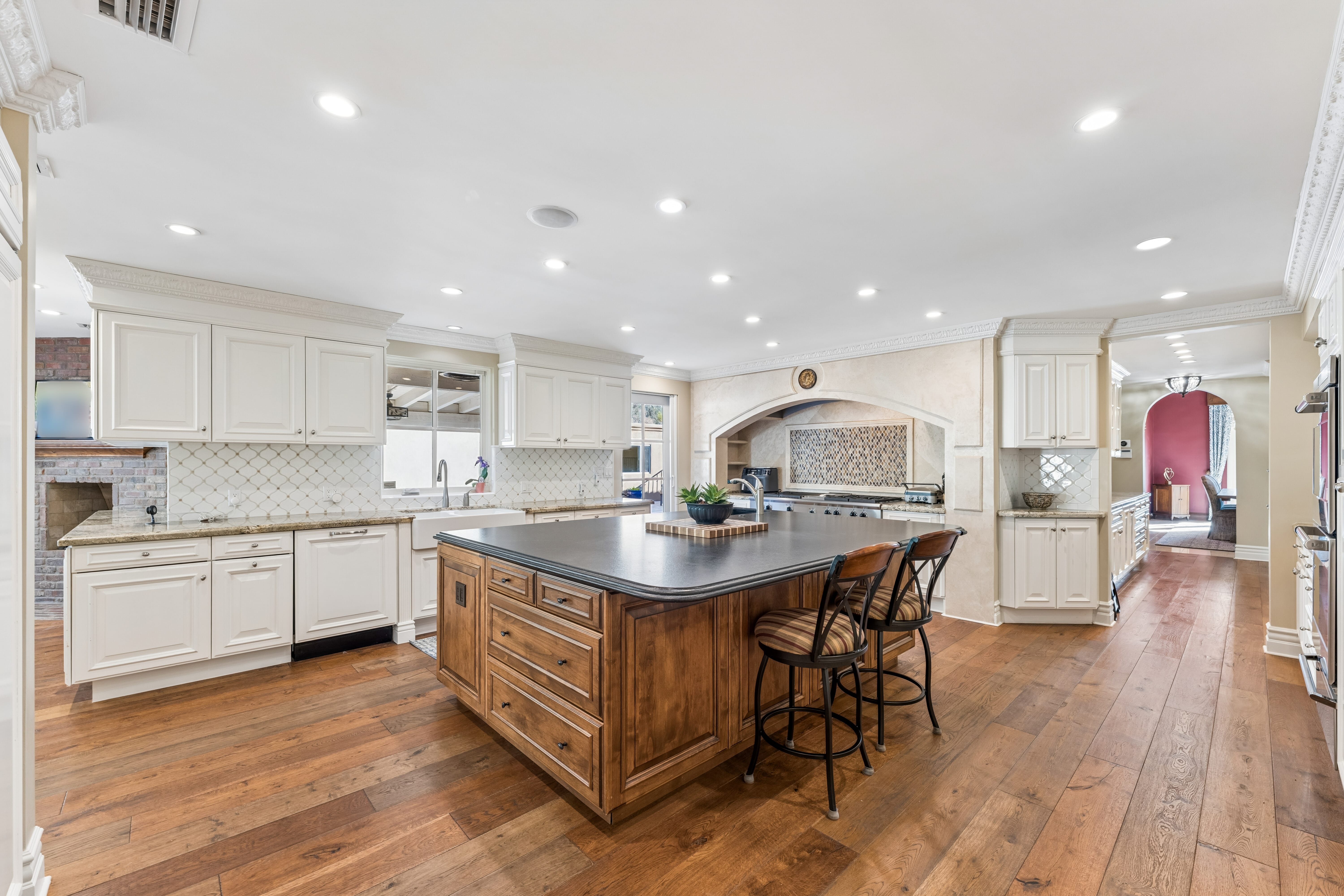 Kitchen full view with walnut island and white cabinetry