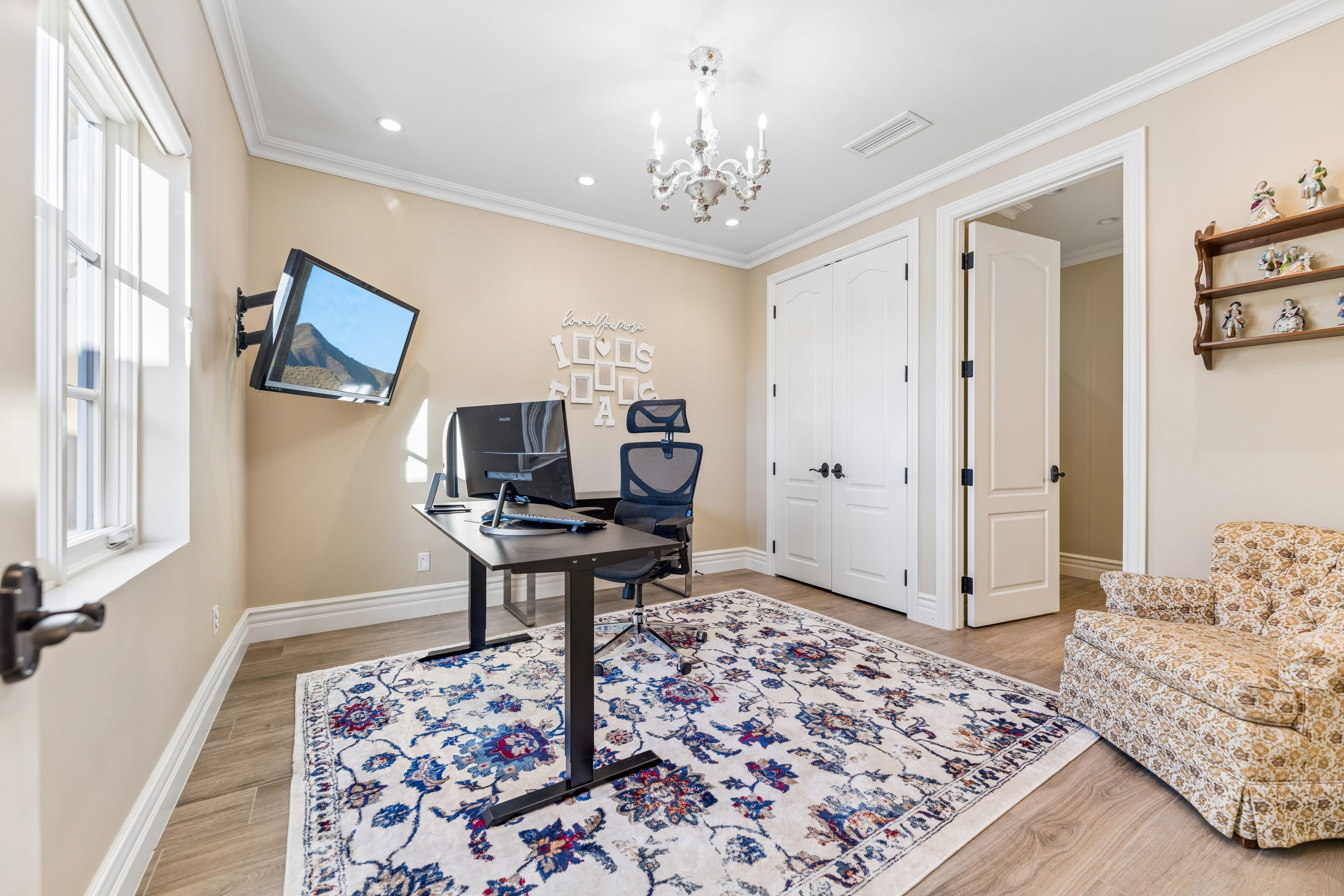 Second office or nursery with chandelier and mountain view window