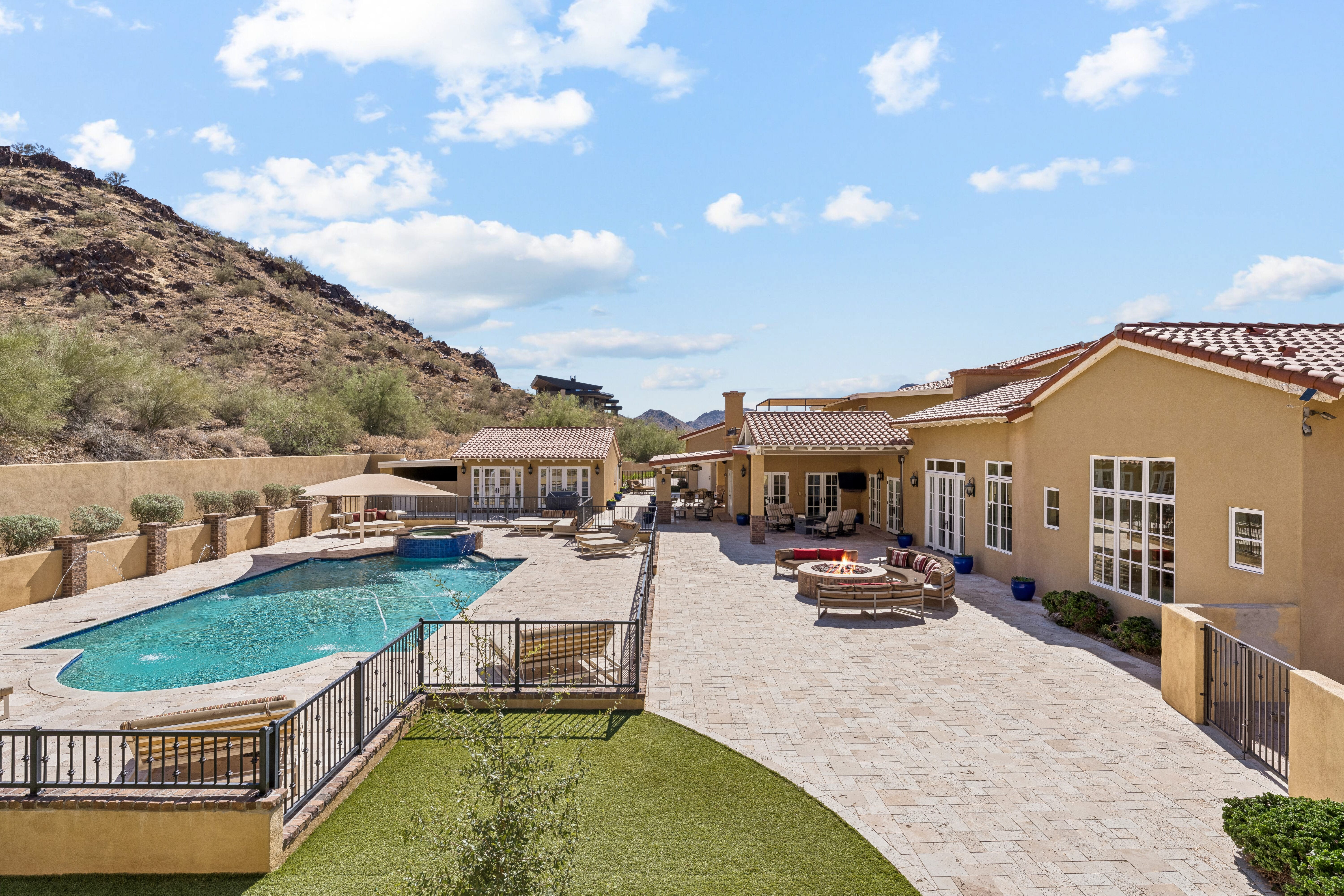 Elevated overview of pool, fire pit, covered patio and all structures