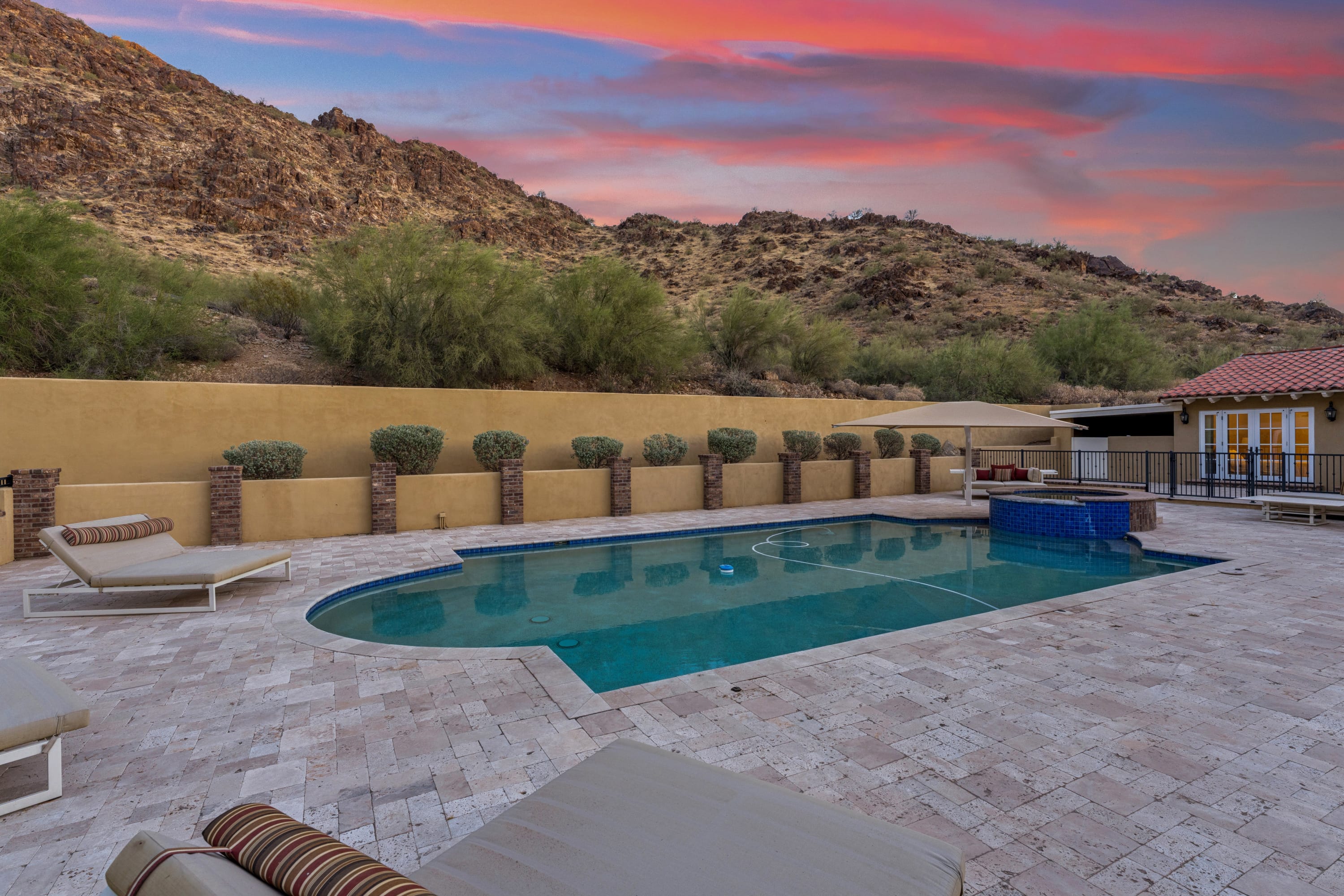 Pool at sunset with pink sky and canyon